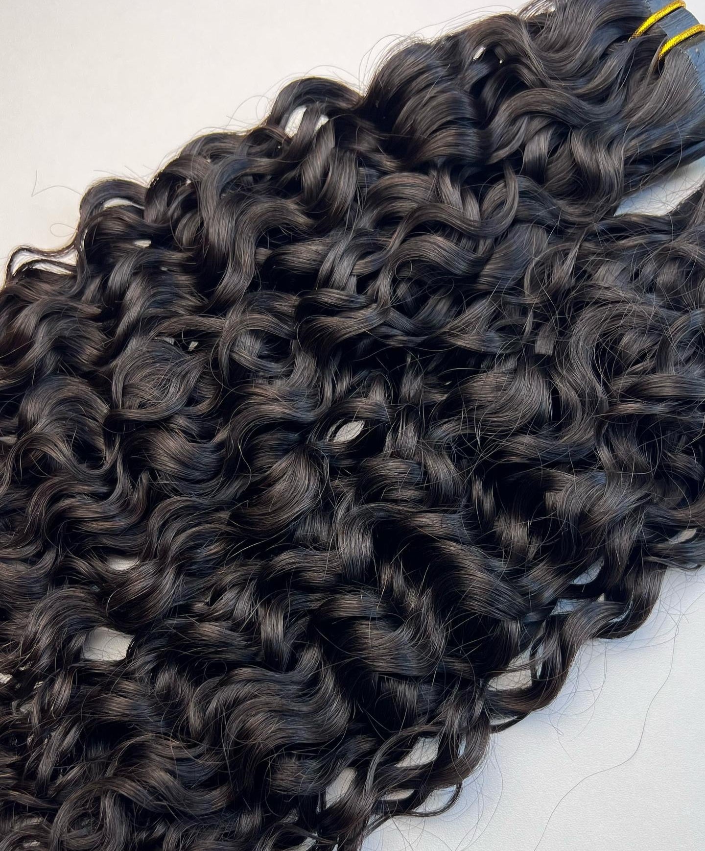 Curly hair extensions on a white background
